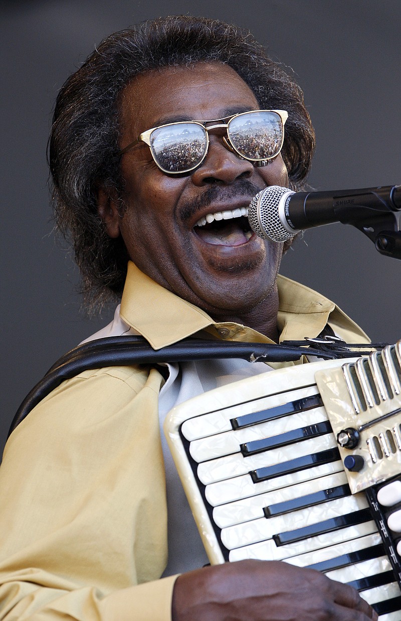 In this May 6, 2011 file photo, Buckwheat Zydeco performs at the'New Orleans Jazz and Heritage Festival in New Orleans.  Stanley "Buckwheat" Dural Jr., who introduced zydeco music to the world through his namesake band Buckwheat Zydeco, has died. He was 68. His longtime manager Ted Fox told The Associated Press that Dural died early Saturday, Sept. 24, 2016. He had suffered from lung cancer.