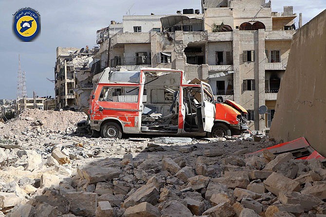 A destroyed ambulance is seen Friday outside the Syrian Civil Defense main center after airstrikes in Ansari neighborhood in the rebel-held part of eastern Aleppo, Syria. A Syria monitoring group and a rescue worker say an intense air bombing campaign has targeted several neighborhoods in rebel-held part of Aleppo city, including centers of the award-winning volunteer civil defense group known as the White Helmets. 