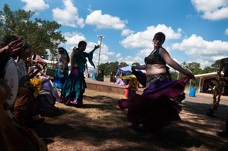 Carrie "Mouse" Slay, right, belly dances Saturday inside of a drum circle during the fifth annual Texarkana Renaissance Faire at the Four States Fairgrounds. 
