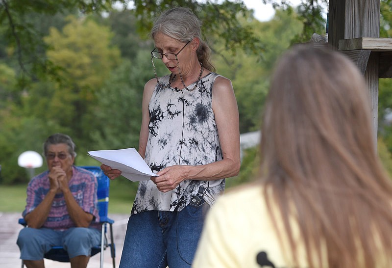 Diane Rowe reads a poem in memory of her father at the Missouri Missing and Parents of Murdered Children's dove release Saturday, Sept. 24, 2016 for the National Day of Remembrance for Murder Victims at McKay Park in Jefferson City. Rowe's father was murdered by her son, who she visits weekly.