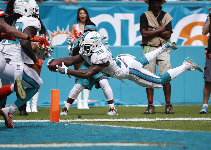 Miami Dolphins running back Damien Williams (26) stretches for a touchdown during the second half of an NFL football game against the Cleveland Browns, Sunday, Sept. 25, 2016, in Miami Gardens, Fla. 