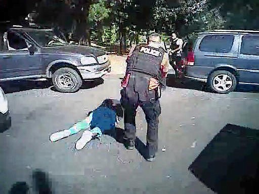 This image made from video provided by the Charlotte-Mecklenburg Police Department on Saturday, Sept. 24, 2016 shows Keith Scott on the ground as police approach him in Charlotte, N.C., on Sept. 20, 2016. 