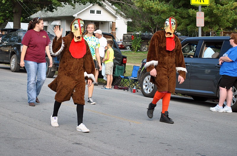 The Eldon Turkey Festival mascots wave to spectators during the event's parade Saturday, Sept. 24, 2016.