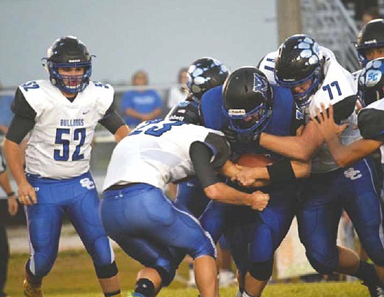 South Callaway senior nose tackle Ben Shumate (77) and junior linebacker Kaden Helsel (23) put the squeeze on a Mark Twain running back during the Bulldogs' 28-6 EMO win over the Tigers on Friday night at Center. (Wes Sconce/Contributed photo)