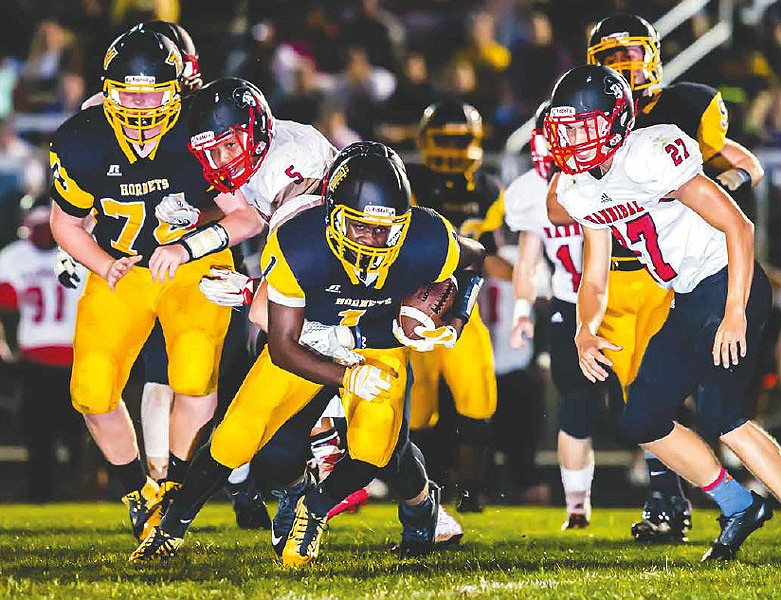 Fulton junior wide receiver L'Trevion Vaughn tries to shift away from Hannibal defenders after making a catch in the Hornets' 75-22 NCMC loss to the state-ranked Pirates on Friday night at Robert E. Fisher Jr. Stadium.