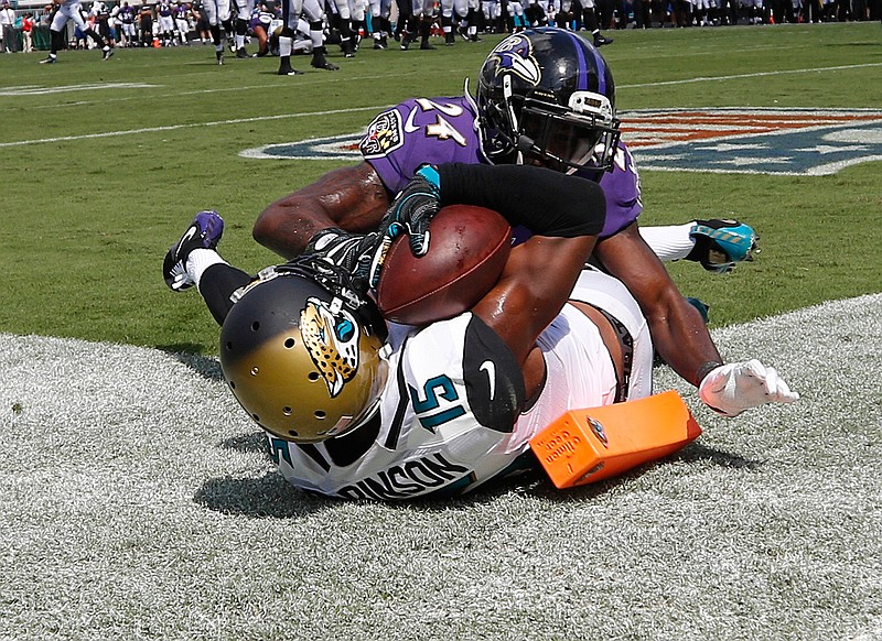 Jacksonville Jaguars wide receiver Allen Robinson (15) catches an 11-yard pass for a touchdown in front of Baltimore Ravens cornerback Shareece Wright during the second half of an NFL football game in Jacksonville, Fla., Sunday, Sept. 25, 2016. 