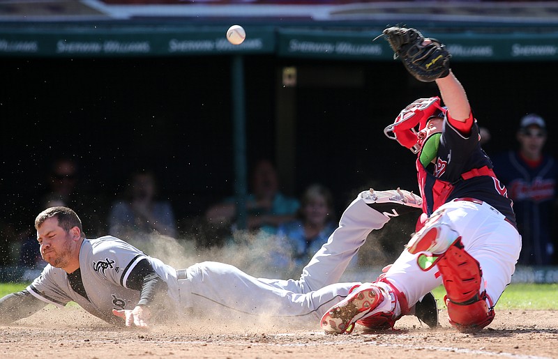 Chicago White Sox' J.B. Shuck is safe at home plate as Cleveland Indians catcher Chris Gimenez is unable to hang onto the ball during the seventh inning of a baseball game Sunday, Sep, 25 2016, in Cleveland. 