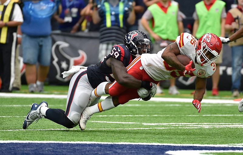 Kansas City Chiefs running back Charcandrick West is tackled by Texans linebacker Whitney Mercilus during last Sunday's game in Houston.