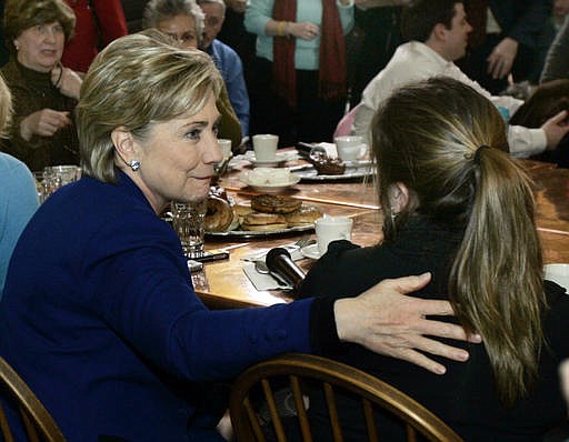 In this Jan. 7, 2008 file photo, Democratic presidential hopeful Sen. Hillary Clinton, D-N.Y., left, talks to Laura Styles of Exeter, N.H., after become emotional while answering a question from an undecided voter at a cafe in Portsmouth, N.H. Of this "coffee shop moment," biographer Gail Sheehy says, "She allowed herself to show a little vulnerability _ in spite of herself _ and wow, women all over the place related to her." 