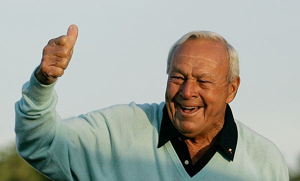This April 5, 2007, file photo shows former Masters champion Arnold Palmer acknowledging the crowd after hitting the ceremonial first tee shot prior to the first round of the Masters at the Augusta National Golf Club in Augusta, Ga.