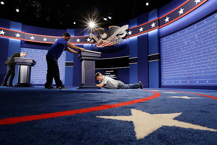 Technicians set up the stage for the presidential debate between Democratic presidential candidate Hillary Clinton and Republican presidential candidate Donald Trump at Hofstra University in Hempstead, N.Y.