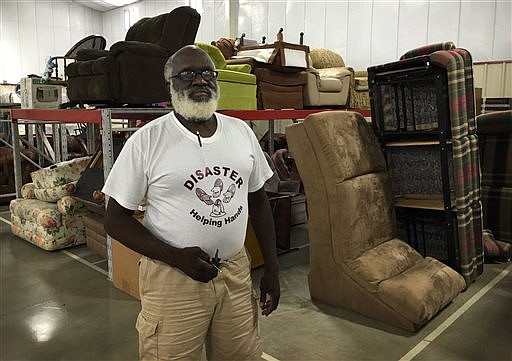 In this Sept. 3, 2016 photo, founder Leon Green stands within Disaster Helping Hands' new warehouse, where furniture and household goods are at the ready for the next time disaster strikes a community near or far in Wichita Falls, Texas. While Wichita Falls, Texas and surrounding communities will always get priority, DHH volunteers have traveled across the country to bring donations and support to victims of tornadoes, floods and other disasters.