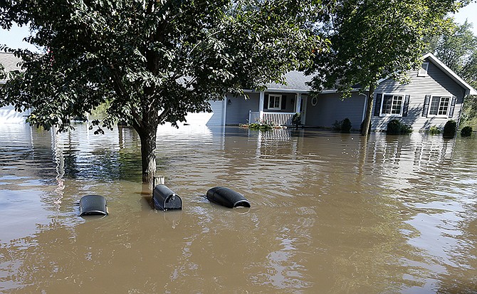 The tops of mailboxes barely break the surface of floodwaters from the Cedar River in the North Cedar neighborhood of Cedar Falls, Iowa.