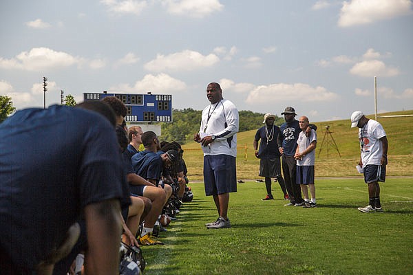 Lincoln head coach Mike Jones addresses his team following the first practice of the team's training camp prior to the 2015 season.