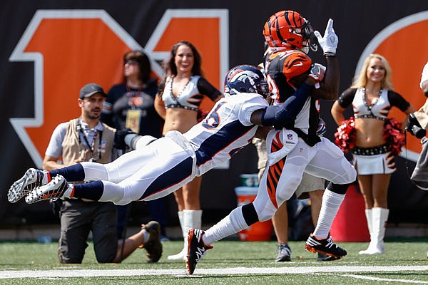 Bengals running back Jeremy Hill is tackled by Broncos free safety Darian Stewart during the first half of Sunday's game in Cincinnati.