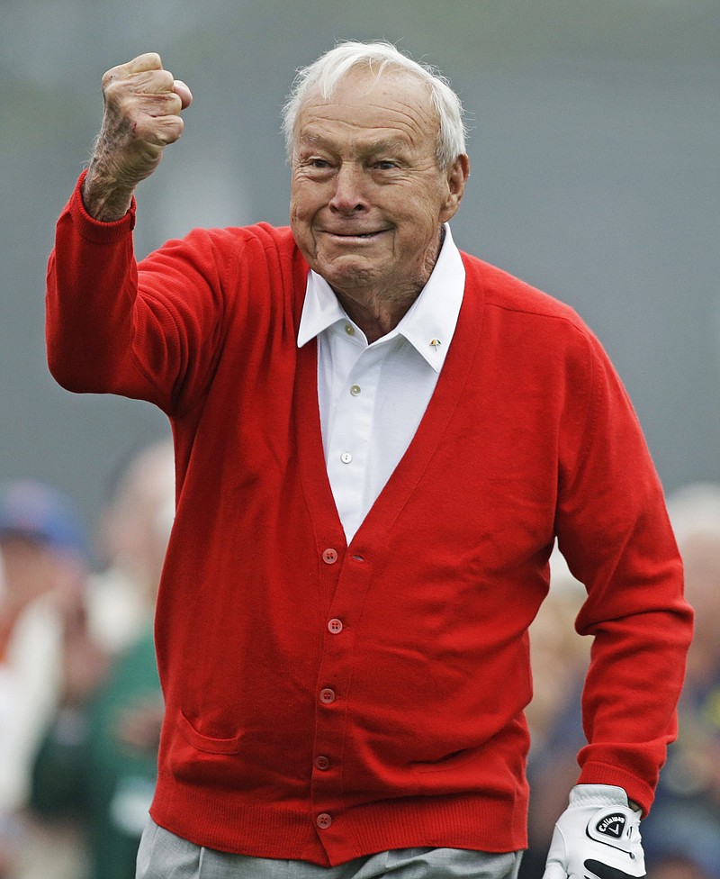 Honorary starter Arnold Palmer puts his fist up after hitting off the first tee before the first round of the Masters golf tournament April 11, 2013, in Augusta, Ga.
