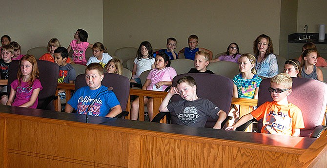 California second grade students learn about the workings of the city government. The four students in front are in the seats normally occupied by the fire chief, police chief, park supervisor and street supervisor.