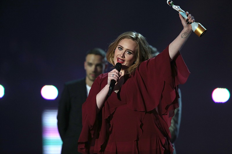 In this Feb. 24, 2016 file photo, Adele holds the Best British Female Solo Artist award onstage at the Brit Awards 2016 at the 02 Arena in London.
