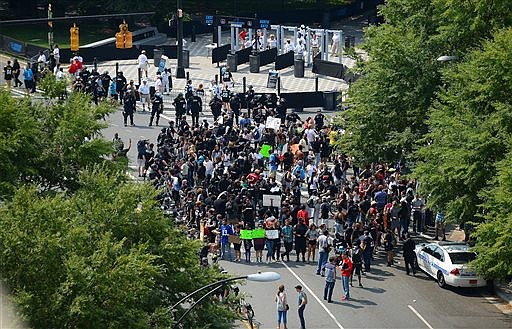 Protesters gather outside Bank of America Stadium in Charlotte, N.C., Sunday, Sept. 25, 2016. The Carolina Panthers hosted an NFL football game with the Minnesota Vikings at the stadium. When the national anthem was played, the protesters all dropped to one knee as many NFL players have been doing for weeks to call attention to issues, including police shootings. (Jeff Siner/The Charlotte Observer via AP)