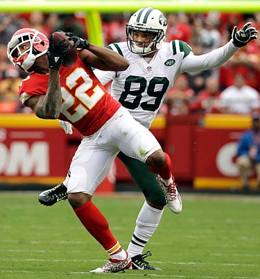 Chiefs cornerback Marcus Peters intercepts a ball intended for Jets wide receiver Jalin Marshall in the first half of Sunday's game at Arrowhead Stadium.