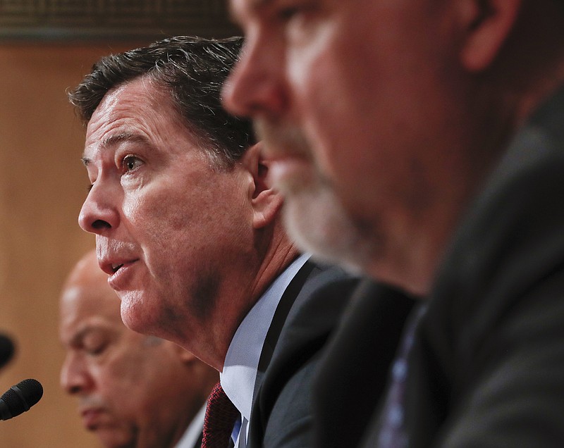 Then-FBI Director James Comey, center, flanked by Homeland Secretary Jeh Johnson, left, and Director of National Counterterrorism Center, Office of the National Intelligence, Nicholas J. Rasmussen, testifies Tuesday, Sept. 27, 2016, on Capitol Hill in Washington before the Senate Homeland Security and Governmental Affairs Committee hearing on on terror threats.