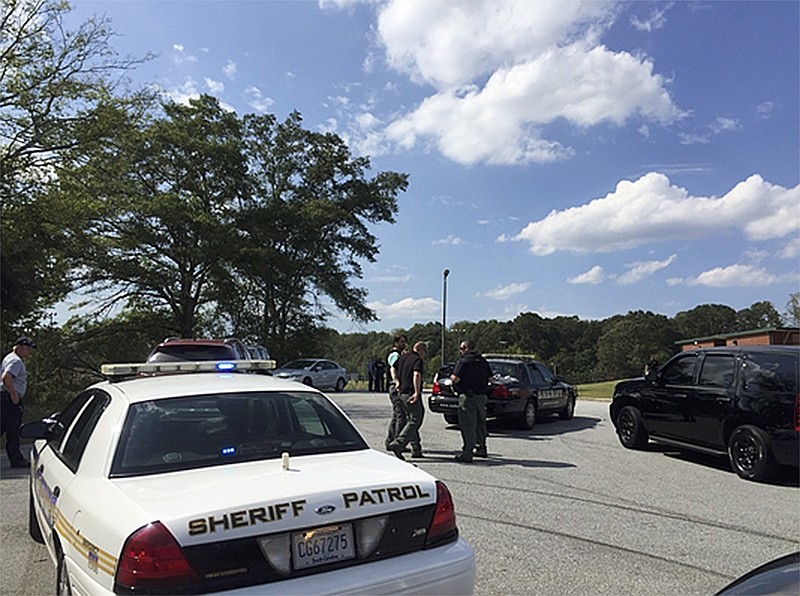 Authorities speak as they respond to a report of a shooting at a South Carolina elementary school Sept. 28, 2016, in Townsville, S.C.