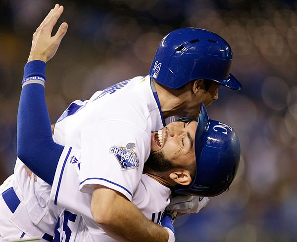 Billy Burns (top) of the Royals celebrates his game-winning sacrifice fly with Eric Hosmer (bottom) in the 11th inning of a Tuesday night's game against the Twins at Kauffman Stadium in Kansas City.