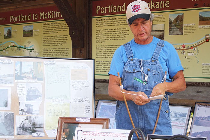 Mike Offineer, former railroad engineer, demonstrates how to use a train order fork during the trip to Portland.