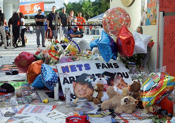 Items sit at a makeshift memorial in memory of Marlins pitcher Jose Fernandez outside of Marlins Park, prior to Tuesday night's game against the Mets in Miami.