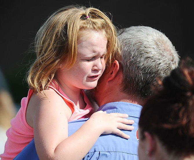 Lilly Chapman, 8, cries after being reunited with her father, John Chapman, Wednesday at Oakdale Baptist Church in Townville, South Carolina. Students were evacuated to the church following a shooting at Townville Elementary School. 