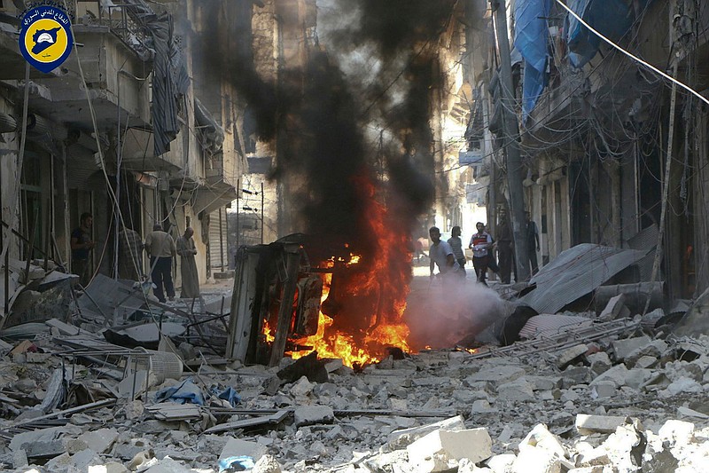 In this photo provided by the Syrian Civil Defense group known as the White Helmets, Syrians inspect damaged buildings after airstrikes by government helicopters on the rebel-held Aleppo neighborhood of Mashhad, Syria, Tuesday Sept. 27, 2016. With diplomacy in tatters and a month left to go before U.S. elections, the Syrian government and its Russian allies are using the time to try and recapture the northern city of Aleppo, mobilizing pro-government militias in the Old City and pressing ahead with the most destructive aerial campaign of the past five years. 