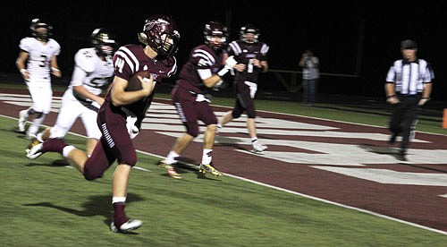School of the Osage junior quarterback Zach Wheeler heads for the end zone during Tri-County Conference play against Versailles last Friday night at Osage Beach. Wheeler ran for three touchdowns and passed for another in Osage's 42-6 Homecoming victory.