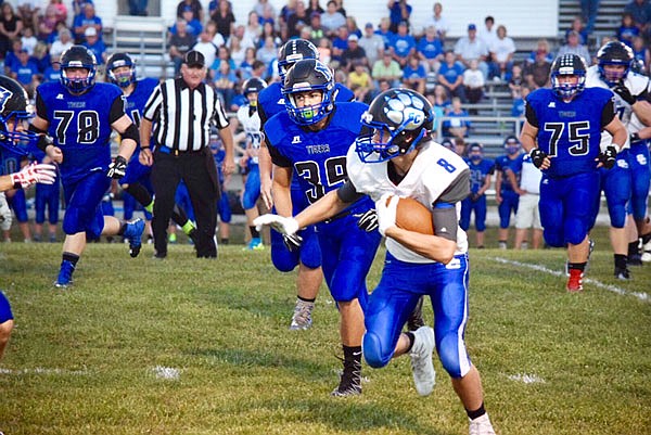 South Callaway junior wide receiver Jarrett Livengood picks up extra yardage after making a catch in the Bulldogs' 28-6 Eastern Missouri Conference win last Friday night at Mark Twain.