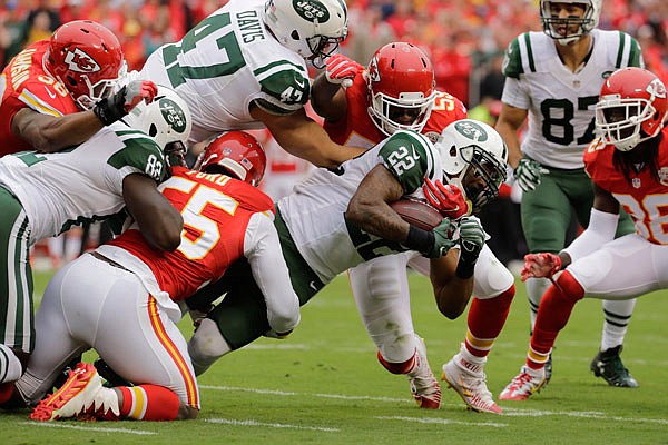 Jets running back Matt Forte is brought down by Chiefs linebacker Dee Ford (left) during the first half of last Sunday's game in Kansas City.
