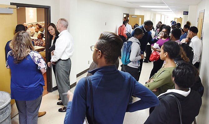 Lincoln University students listen from a hallway Thursday as members of the Faculty Senate discuss a proposed 'no confidence' vote in Said Sewell's work as provost and vice president for Academic Affairs. 