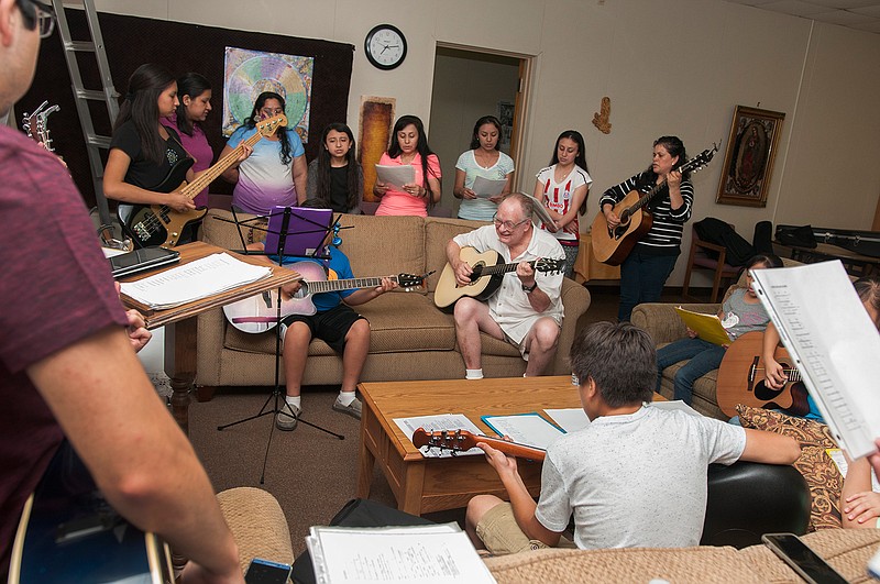 Pete Hamer, center, plays with the St. Edward Catholic Church's Hispanic choir during a practice session Aug. 31 at the church's Bishop Graves Education Building. 