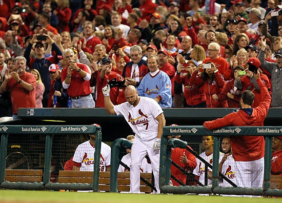 Matt Holliday of the Cardinals makes a curtain call after hitting a solo home run during the seventh inning of Friday night's game against the Pirates at Busch Stadium.