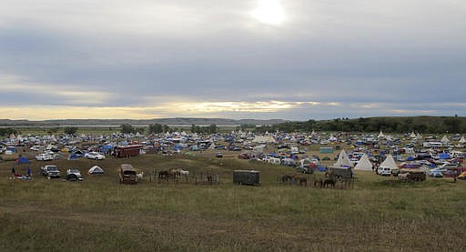 In this Sept. 9, 2016 file photo, More than a thousand people gather at an encampment near North Dakota's Standing Rock Sioux reservation. The sprawling encampment that's a protest against the four-state Dakota Access oil pipeline has most everything it needs to be self-sustaining _ except a federal permit to be there. The camp near the confluence of the Missouri and Cannonball rivers in North Dakota is on U.S. Army Corps of Engineers land.