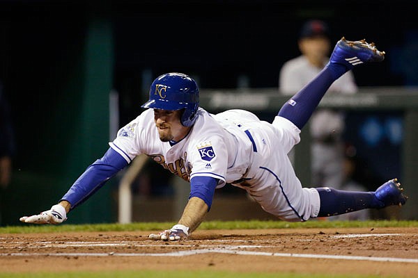 Billy Burns of the Royals dives in to home plate to score during the first inning of Friday night's game against the Indians at Kauffman Stadium.