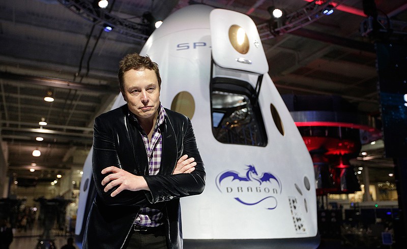 In this Thursday, May 29, 2014 file photo, Elon Musk, CEO and CTO of SpaceX, listens to a question during a news conference in front of the SpaceX Dragon V2 spacecraft, designed to ferry astronauts to low-Earth orbit, at the headquarters in Hawthorne, Calif. The capsule was named for "Puff the Magic Dragon," a jab at those who scoffed when Musk founded the company in 2002 and set the space bar exceedingly high. SpaceX went on to become the first private company to launch a spacecraft into orbit and return it safely to Earth in 2010. 