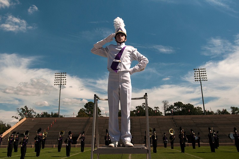 Ashdown High School Marching Band Drum Major Jacob Purifoy salutes the crowd before the band performs Saturday in the Four States Invitational Marching Contest at Tiger Stadium at Grimm Park. 