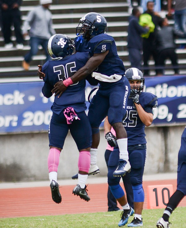 Blue Tigers defensive back Antwon Hoard and running back Will Randolph embrace each other after Hoard recovered a fumble sealing Lincoln University's hard fought victory with the final score of 12-9 against the Lane Dragons at Dwight T. Reed Stadium in Jefferson City, on Saturday, Oct. 1, 2016.