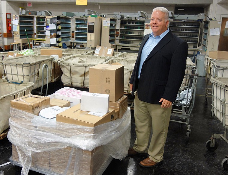 Jason Hirschvogel, the new postmaster of Fulton, stands in the mailroom at the Fulton Post Office on Friday afternoon, Sept. 30, 2016.