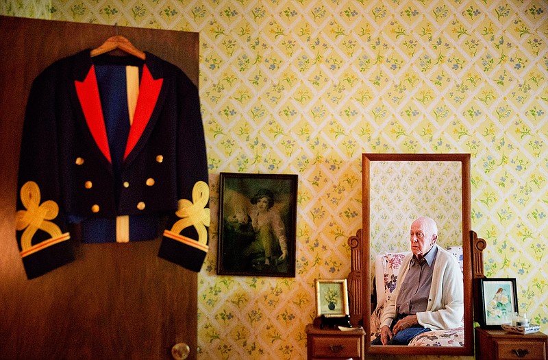 Frank Gleason, 96, a retired colonel with the Office of Strategic Services, looks at his old blue mess dress uniform hanging on a door as he sits in his home in Atlanta, Wednesday, Sept. 28, 2016. Legislation to recognize the contributions of a group of World War II spies is hung up in Congress. Some 75 years ago, the OSS carried out missions behind enemy lines in Nazi Germany and the Pacific theatre. The organization disbanded at the end of the war, but served as a forerunner to the CIA. 