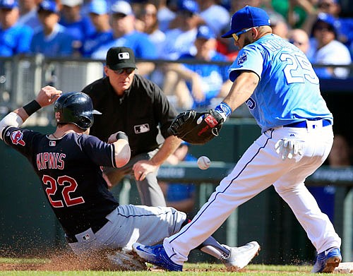 Jason Kipnis of the Indians slides back to first base around Royals first baseman Kendrys Morales during the third inning of Sunday's game at Kauffman Stadium.