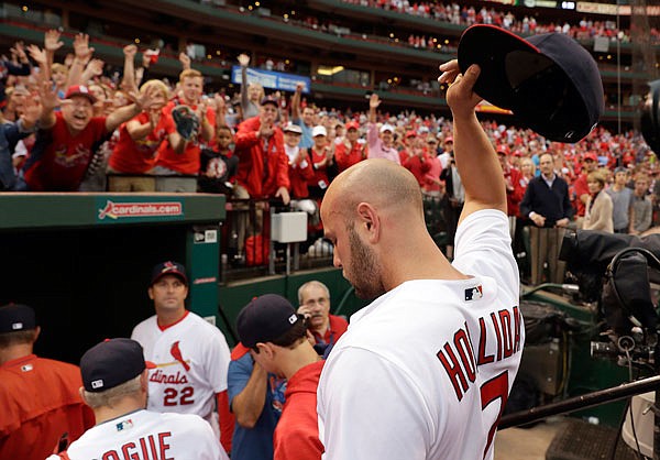 Cardinals outfielder Matt Holliday tips is cap to the fans as he leaves the field following a 10-4 victory against the Pirates in Sunday afternoon's game at Busch Stadium in St. Louis.