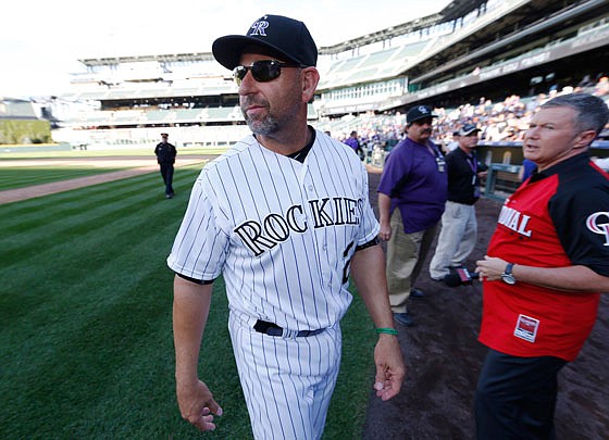 Rockies manager Walt Weiss looks to his right as he walks off the field for the final time as the Rockies skipper Sunday after facing the Brewers in the teams' season finale in Denver.