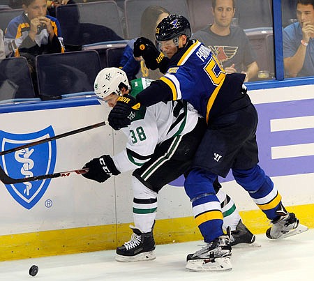 Colton Parayko of the Blues reaches for the puck along with Brendan Ranford of the Stars during a preseason game last week in St. Louis. Parayko is being counted on to play among the top defensemen for the Blues this season.