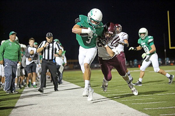 Blair Oaks running back Cody Alexander is pushed out of bounds by a School of the Osage defender during last Friday night's game at the Falcon Athletic Complex in Wardsville. Alexander finished the game with eight receptions for 122 yards, both career highs.