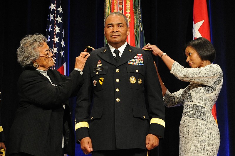 Maxine Piggee, left, and Kassi Piggee, right, pin a third star on Lt. Gen. Aundre Piggee at a special promotion ceremony last month at the Pentagon.